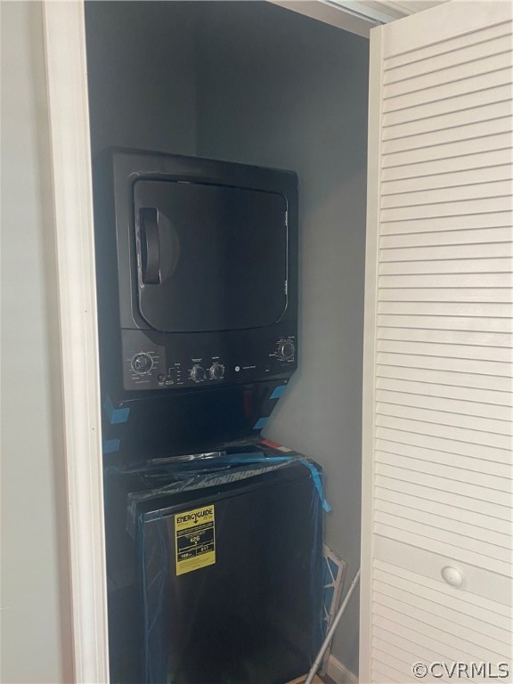 Laundry room featuring stacked washer and dryer