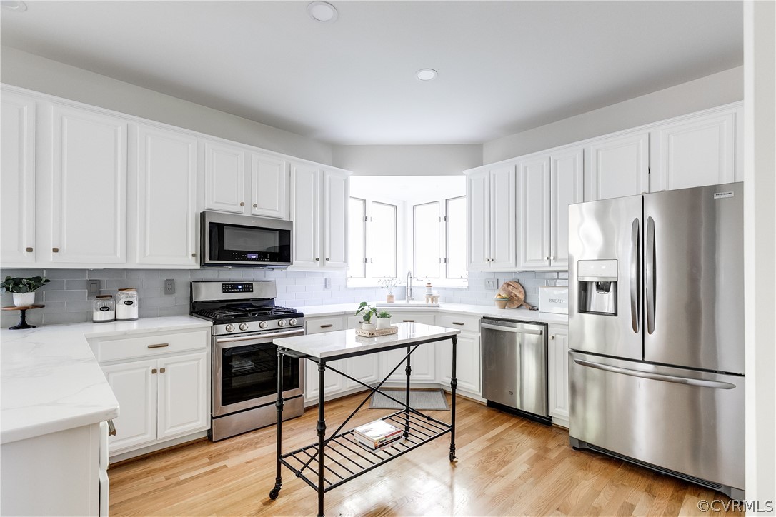 Light & bright kitchen with hardwoods, stainless appliances, quartz counters and stunning detail