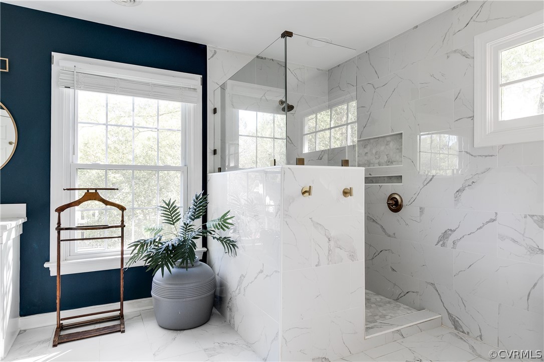 Attached primary bathroom with marble, soaker tub and oversized shower