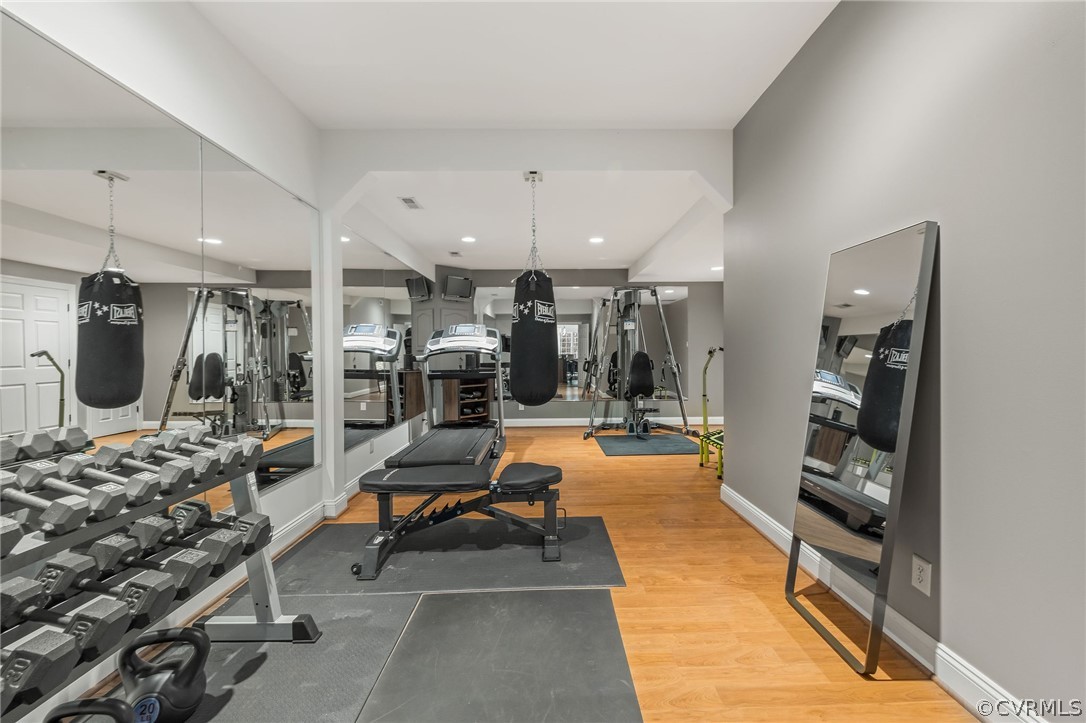 Workout area with light hardwood / wood-style floors