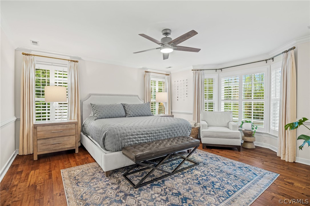 Bedroom featuring ornamental molding, ceiling fan, and dark hardwood / wood-style floors