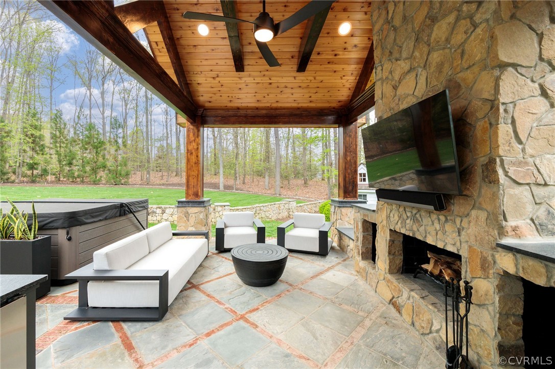 View of patio / terrace featuring ceiling fan and a hot tub