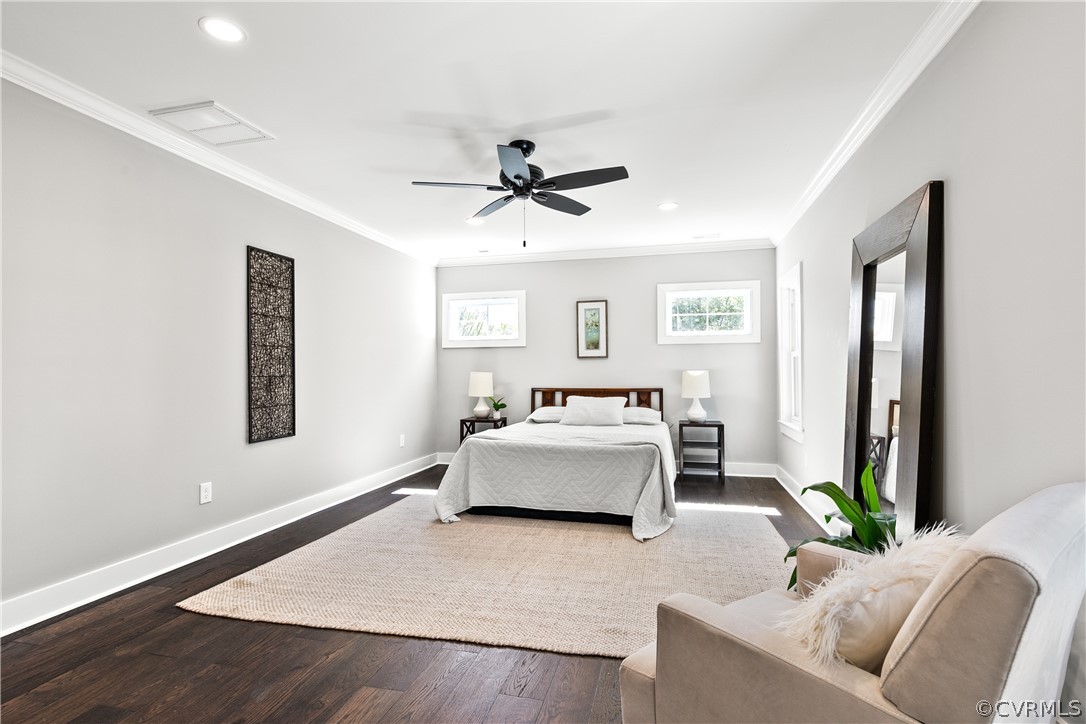 Bedroom with dark hardwood / wood-style floors, ceiling fan, and ornamental molding