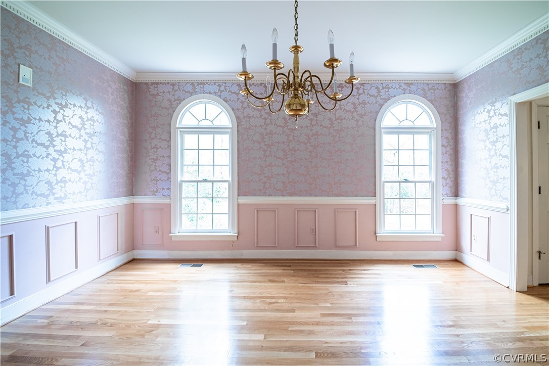 Dining Room with moulding and chandelier