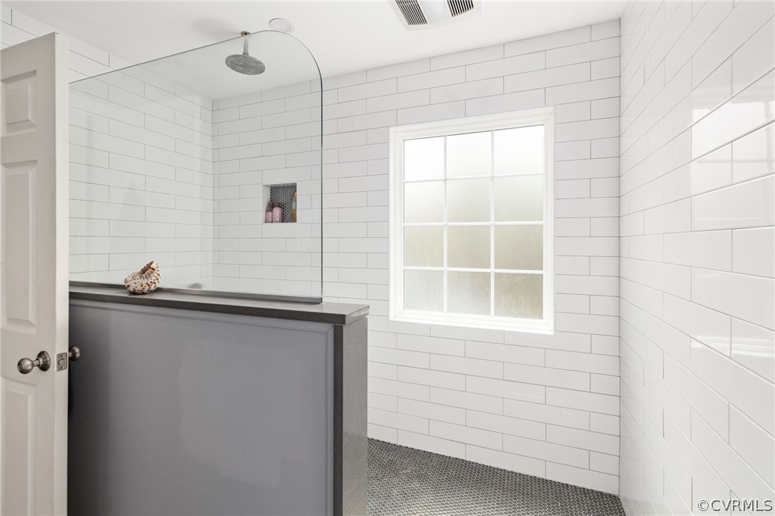 Expansive shower with subway tiles.