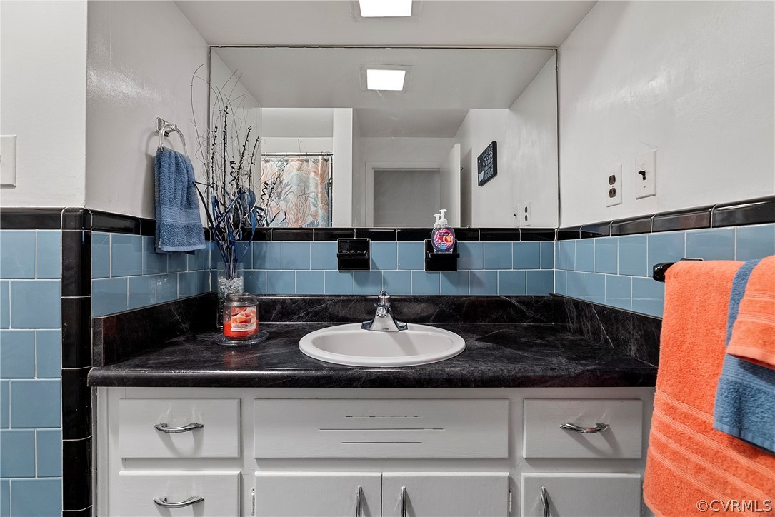 Bathroom featuring backsplash and vanity