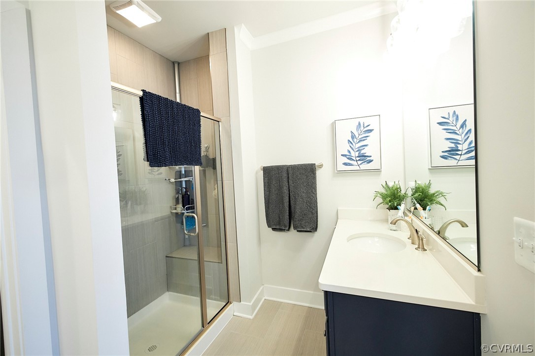 Bathroom with walk in shower, vanity, and tile floors