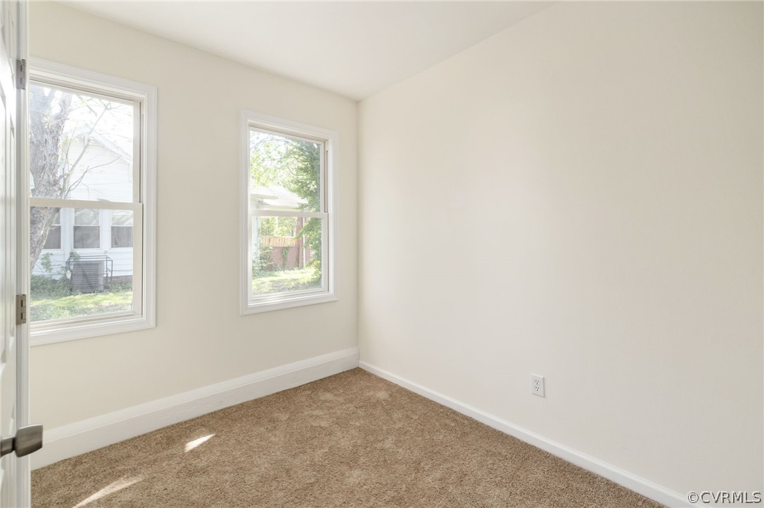 Bedroom with light colored carpet and plenty of natural light