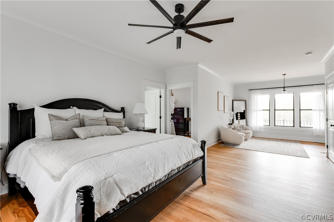 Bedroom with ceiling fan, light hardwood / wood-style floors, and ornamental molding