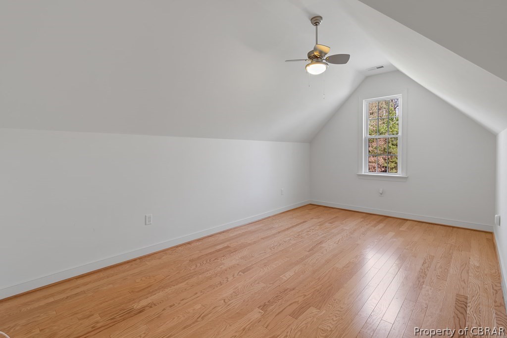 Bonus room featuring lofted ceiling, ceiling fan, and light wood-type flooring