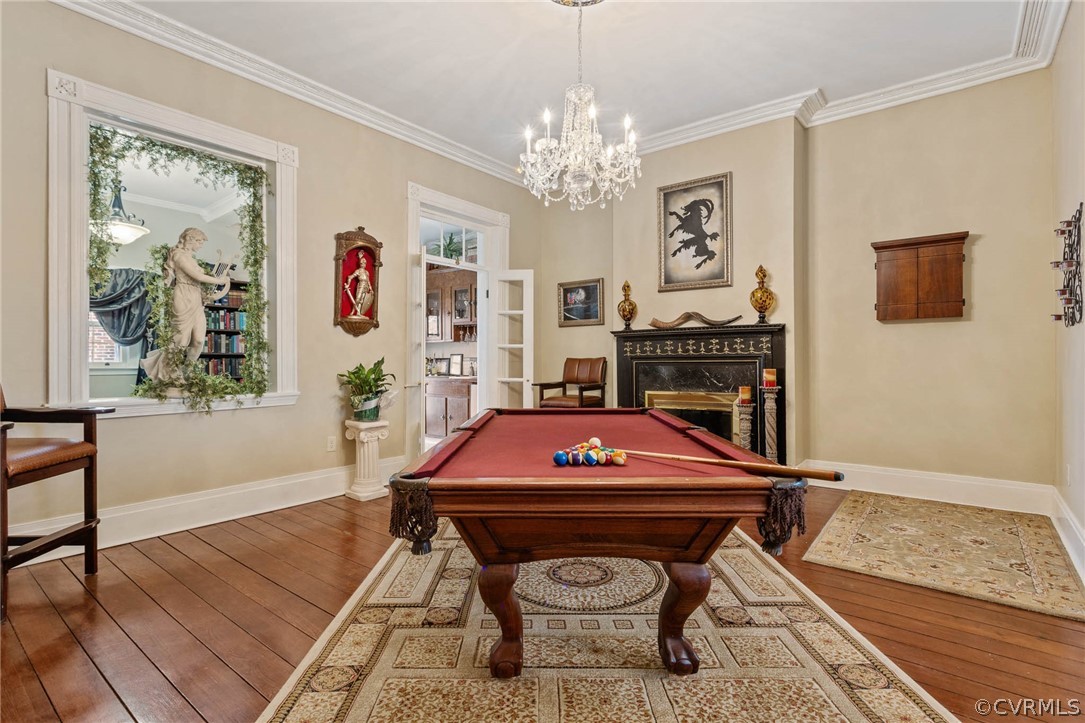 Playroom with hardwood / wood-style flooring, a healthy amount of sunlight, and billiards