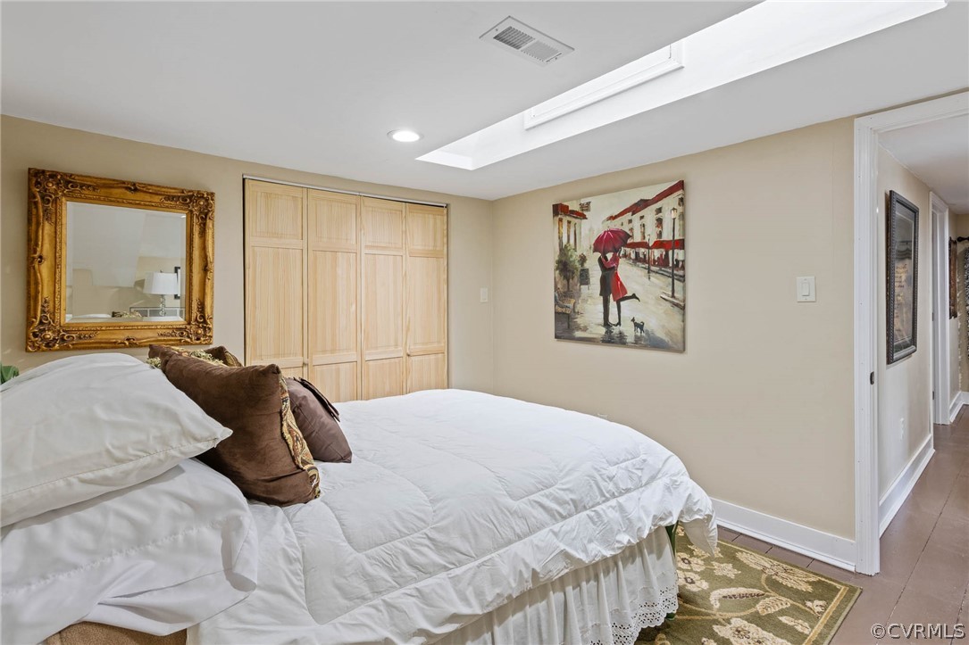 Bedroom with a closet and light hardwood / wood-style flooring