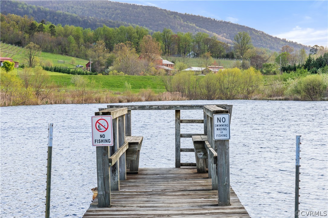 View of dock with a water and mountain view
