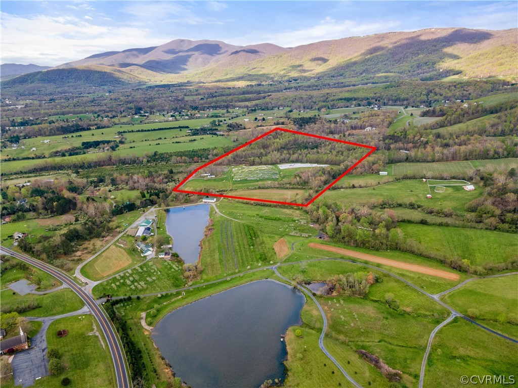 Birds eye view of property with a rural view and a water and mountain view