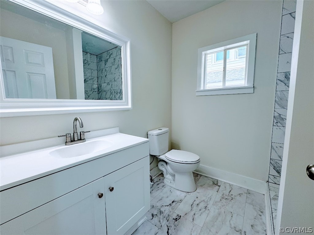 Bathroom featuring tile flooring, vanity, and toilet