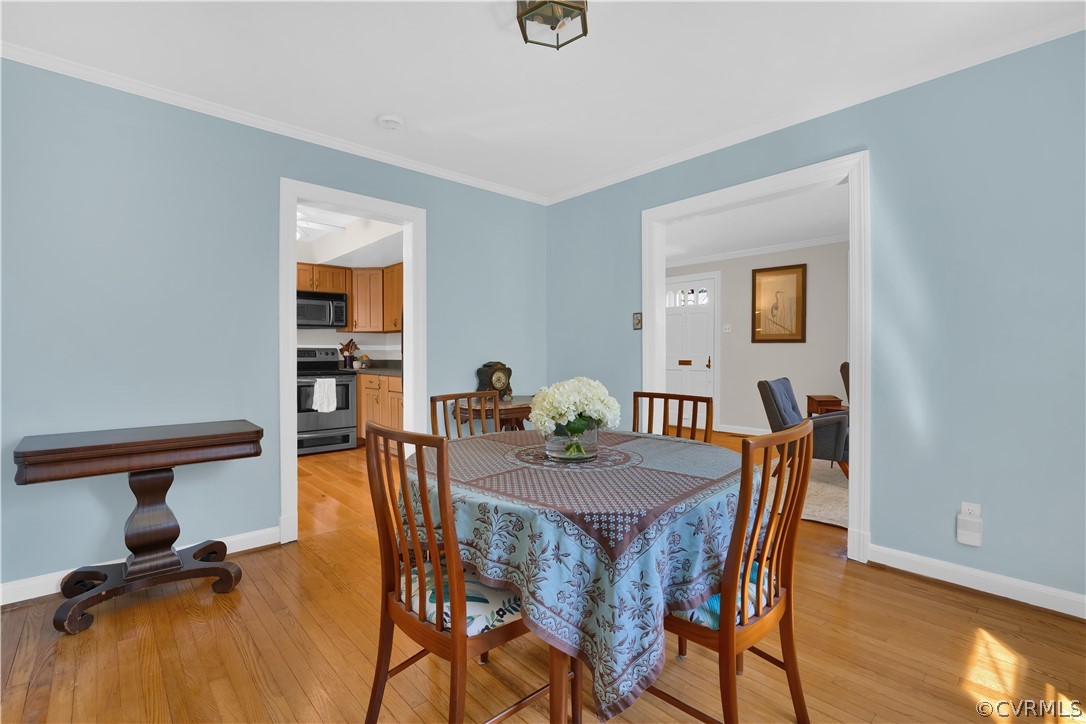 Dining room is freshly painted, has hardwood floors and beautiful natural light!