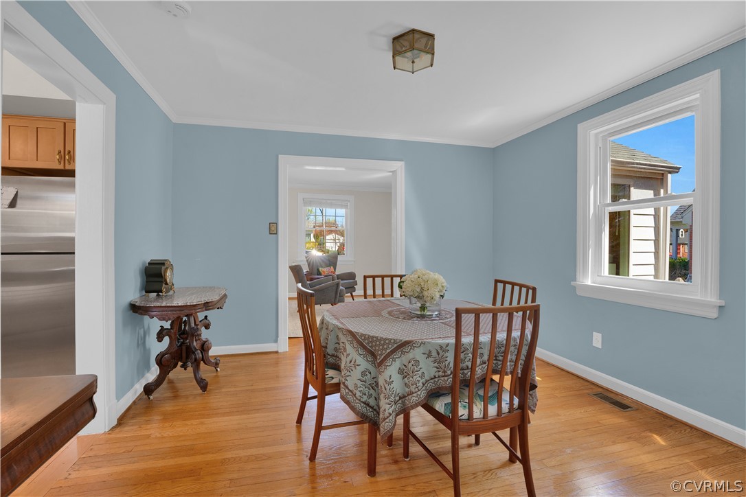 Dining room is freshly painted, has hardwood floors and beautiful natural light!