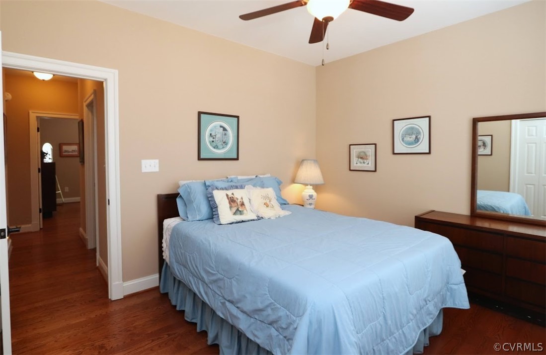 Bedroom with hardwood / wood flooring and ceiling fan