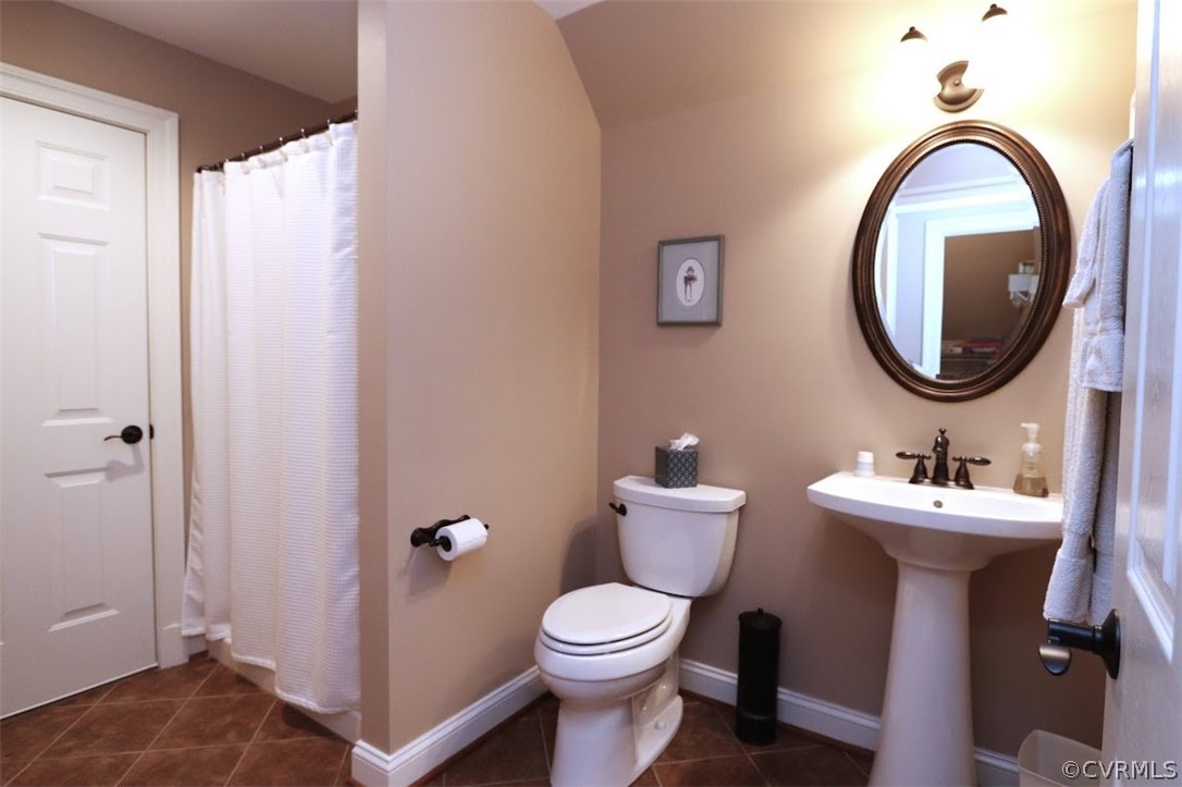 Bathroom featuring tile floors and walk in shower and access to condition attic