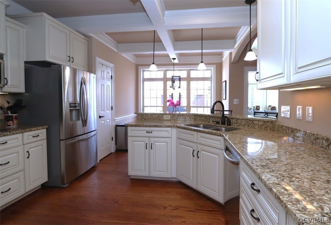 Kitchen with beamed ceiling, coffered ceiling, sink, dark hardwood / wood flooring, and hanging light fixtures