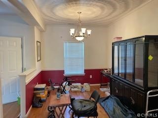Dining space with ornamental molding and a notable chandelier