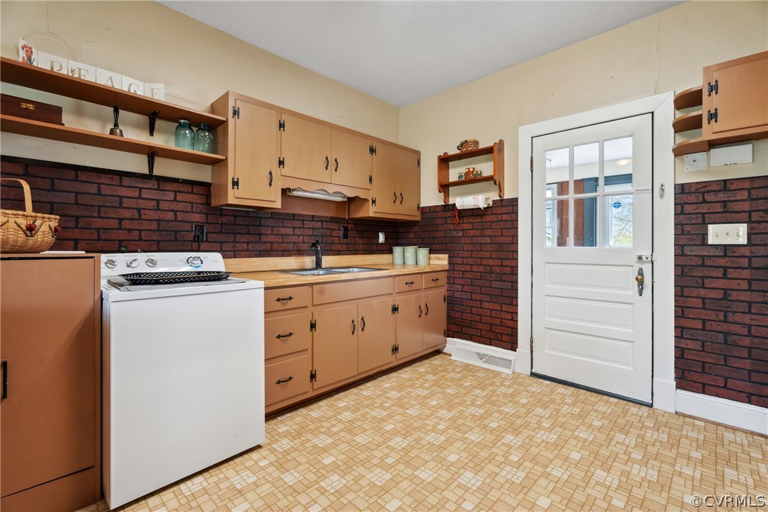 Kitchen featuring sink, white range with electric stovetop, and light tile flooring