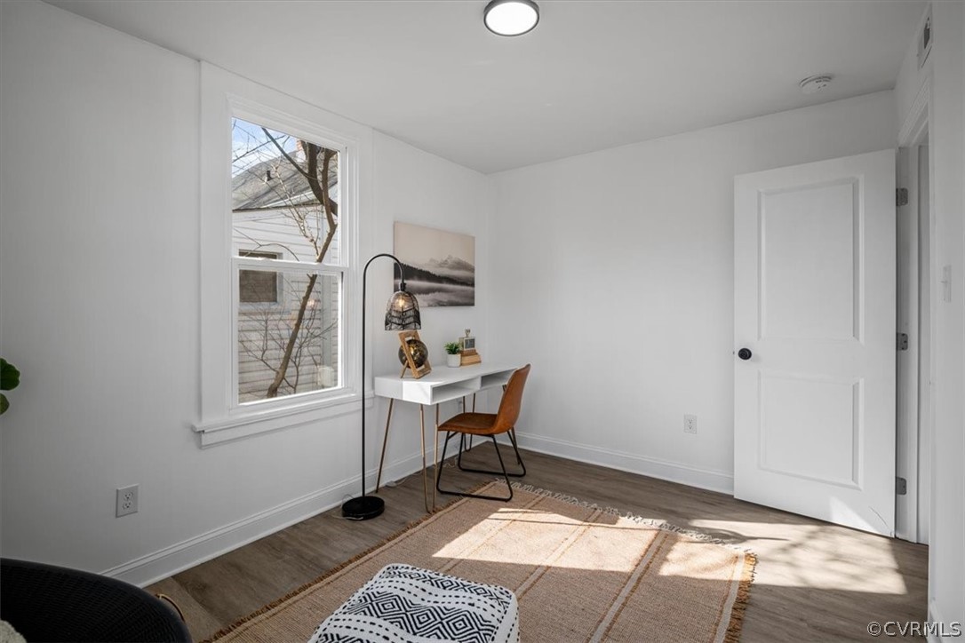 Living area with dark hardwood / wood-style floors