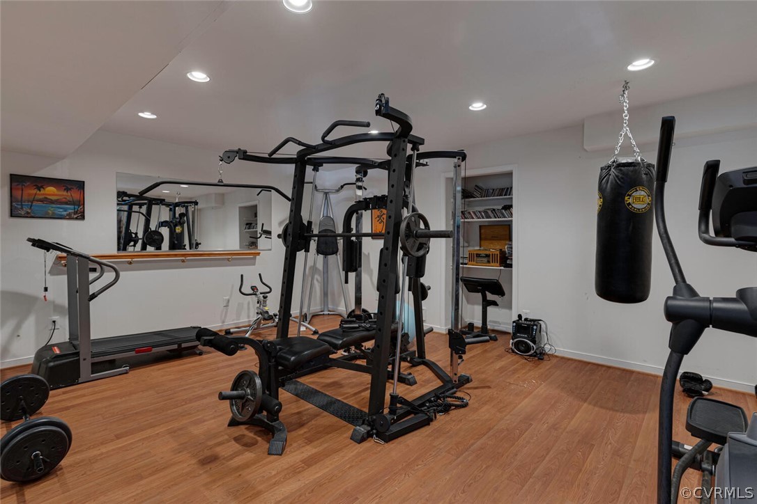 Exercise room or 5th bedroom. There is a mirrored wall to the left and a mirror above the ballet bar for your ballerina. Windows to the right, laminate floor, open shelves that can be converted to a closet, recessed lighting. Equipment can convey.