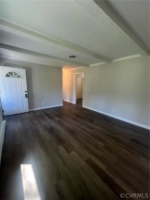 Unfurnished room featuring beamed ceiling and dark wood-type flooring
