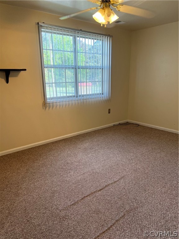 Spare room featuring carpet floors and ceiling fan