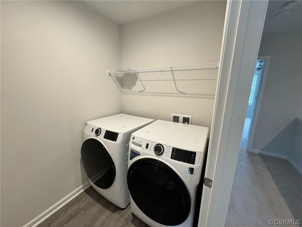 Clothes washing area with wood-type flooring, separate washer and dryer, and hookup for a washing machine