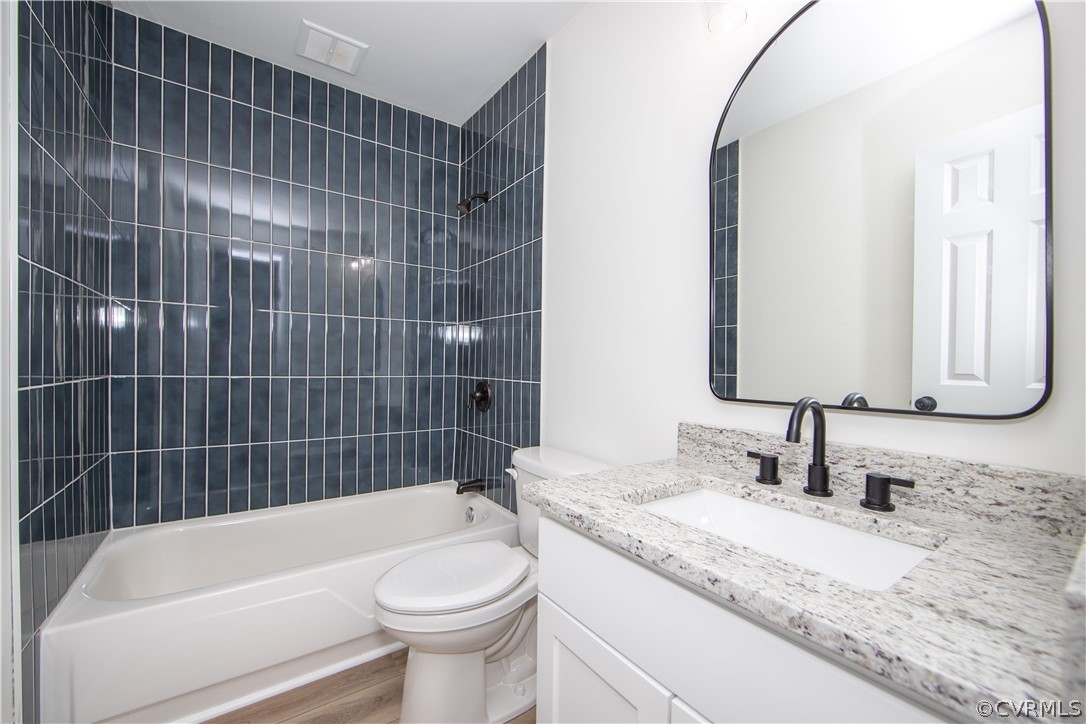 The hall bath offers a tub/shower combo with tile, LVP flooring, and granite counter tops.