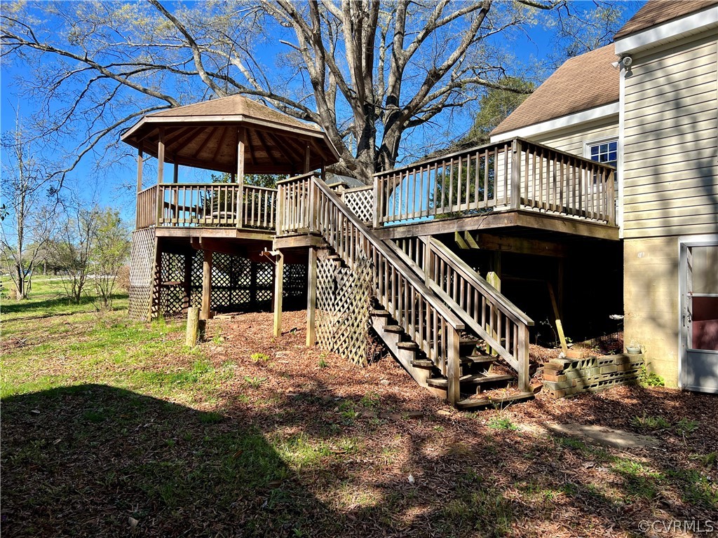 Back of property featuring a wooden deck