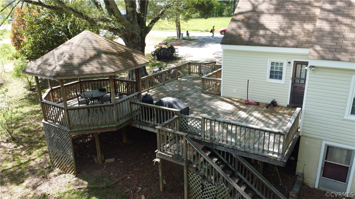 Wooden deck featuring area for grilling and a gazebo