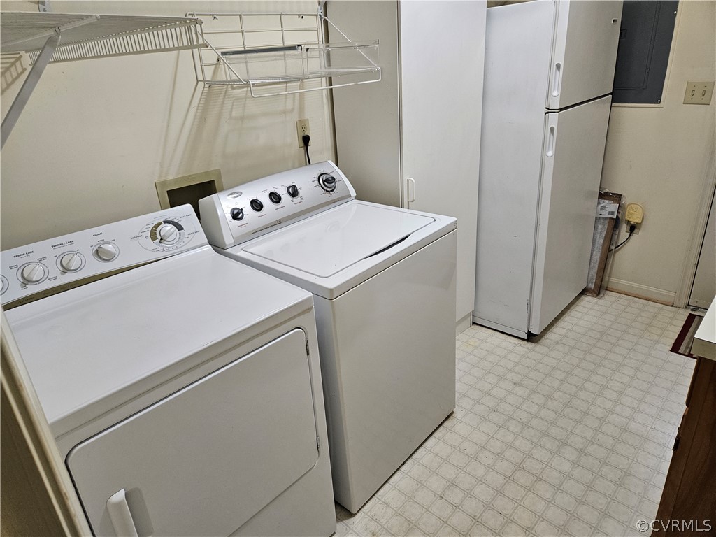Laundry room with washer and clothes dryer, light tile floors, and hookup for a washing machine