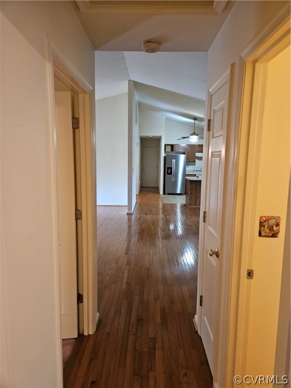 Hall featuring lofted ceiling and dark hardwood / wood-style floors