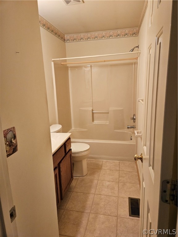 Full bathroom with shower / washtub combination, tile flooring, vanity, and toilet