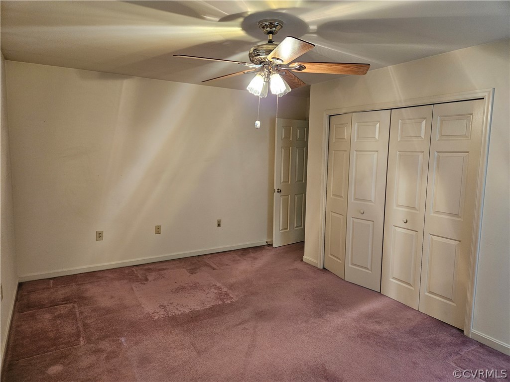 Unfurnished bedroom with a closet, ceiling fan, and carpet