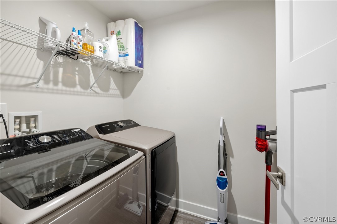 Laundry area with hardwood / wood-style floors, separate washer and dryer, and washer hookup