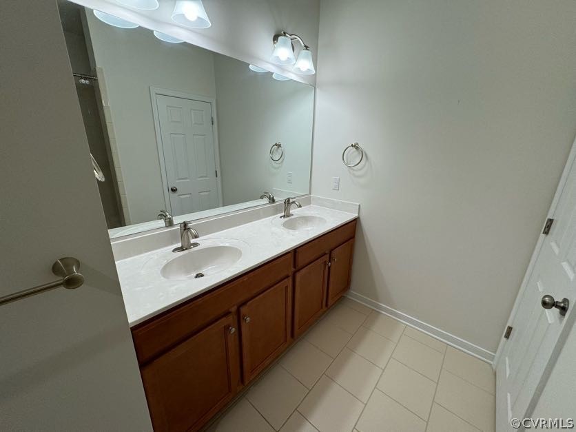 Bathroom featuring tile floors, oversized vanity, and double sink