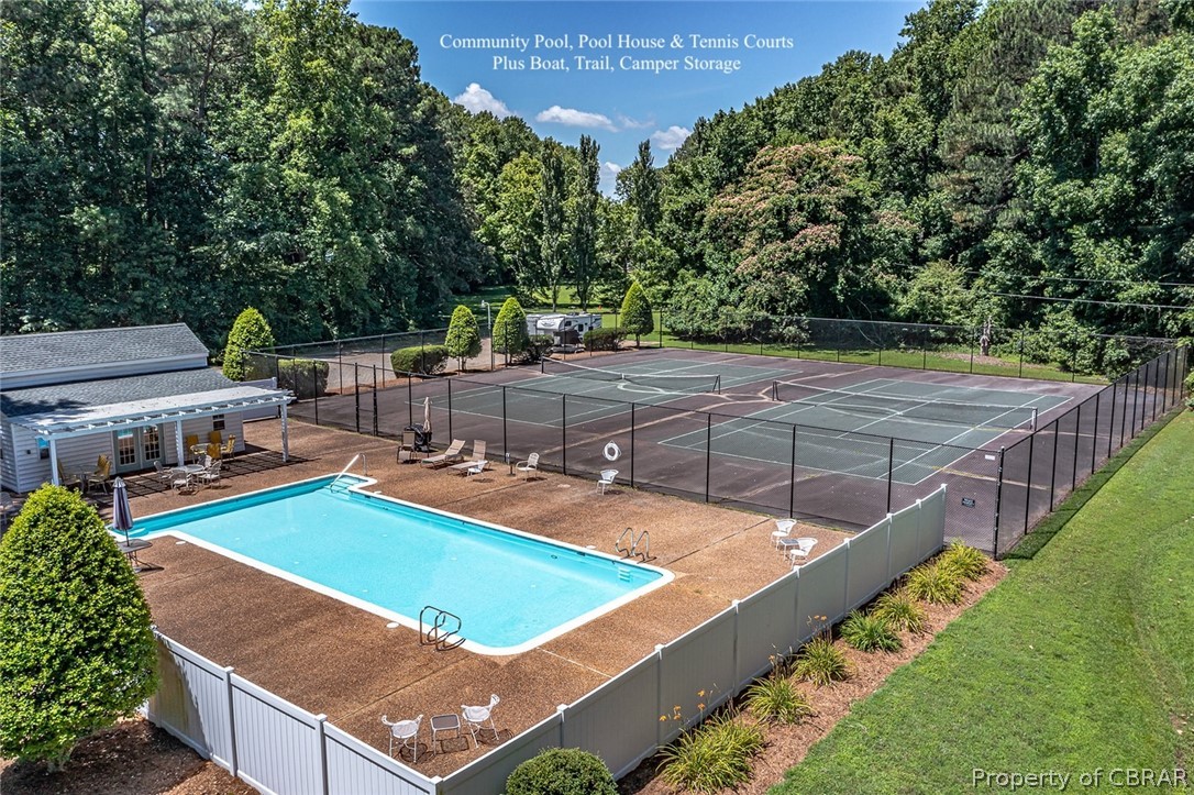 View of pool featuring tennis court