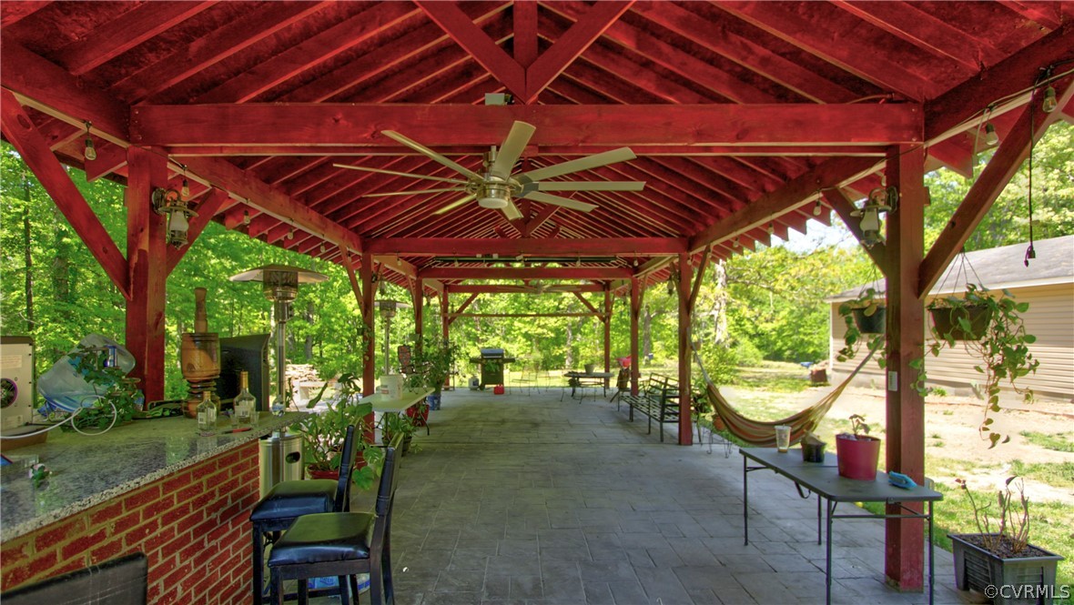 View of patio / terrace featuring an outdoor hangout area, a bar, and a gazebo