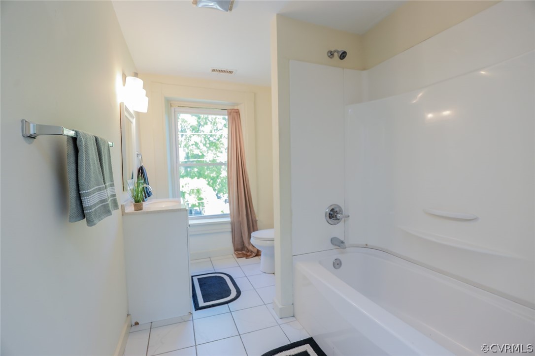 Full bathroom featuring tile flooring, bathtub / shower combination, vanity, and toilet