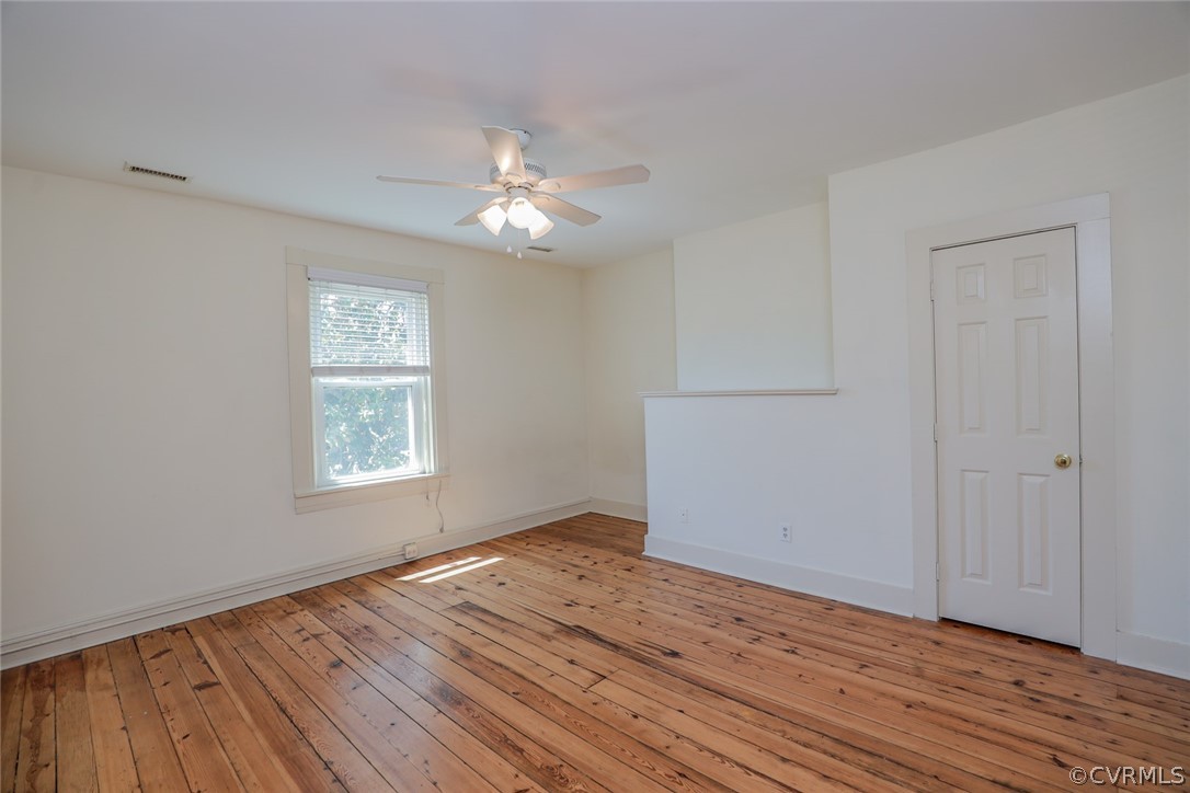 Unfurnished room with hardwood / wood-style floors and ceiling fan
