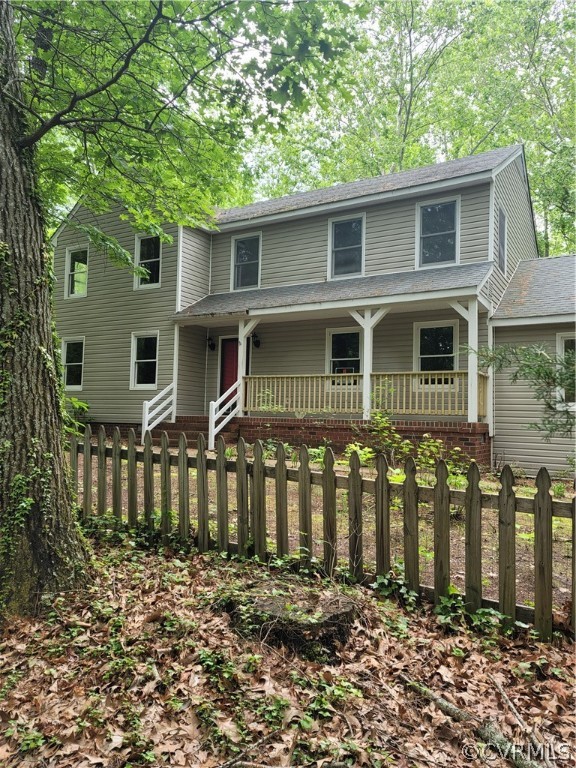 View of side of home with a wooden deck and a yard