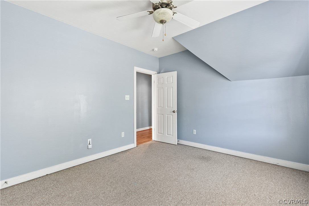 Bonus room featuring lofted ceiling, carpet floors, and ceiling fan