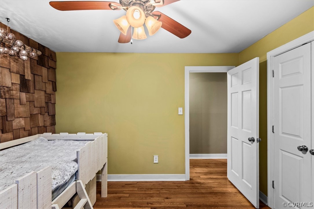 Bedroom featuring ceiling fan and hardwood / wood-style floors