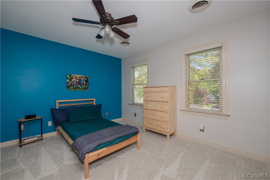 Bedroom 2 with ceiling fan and carpeted flooring!