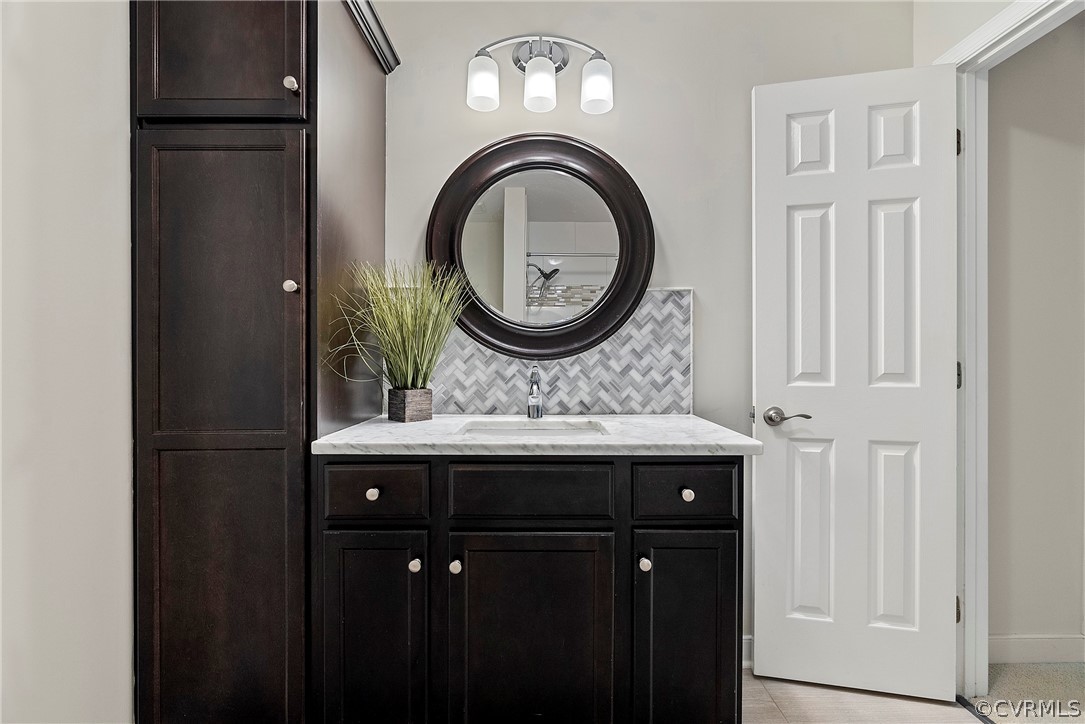 Renovated hall bath with comfort height vanity, granite countertop and abundant storage.