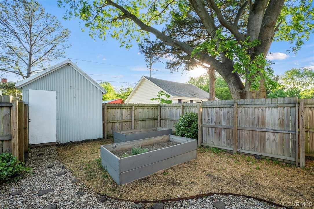 View of backyard with a storage shed